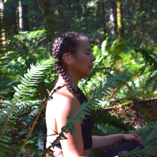 First Nations Yoga Teacher Ivy Richardson sits in meditation in the forests of central Vancouver Island.